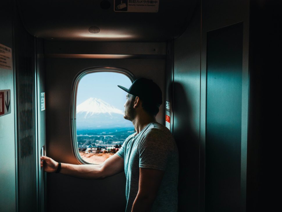 man seeing mt. fuji out a shinkansen window.